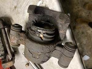 A brake caliper in very poor condition